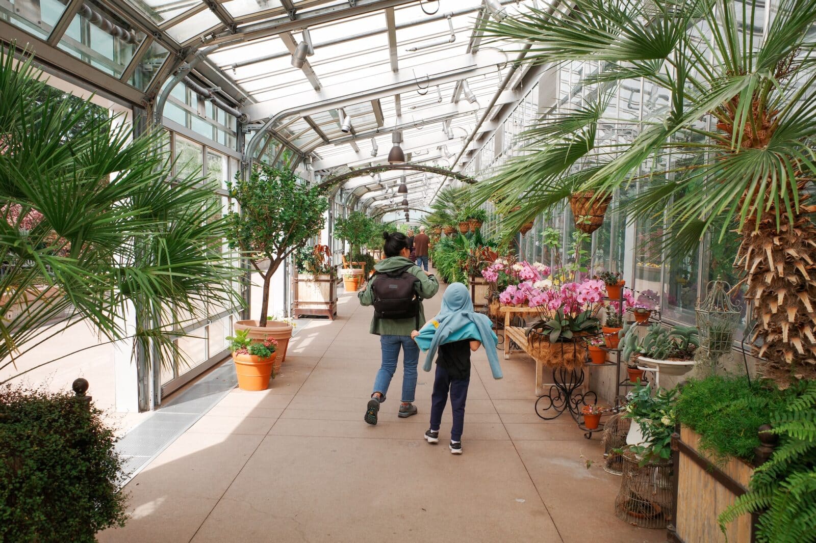 woman and child walk in the greenhouse at Denver Botanic Gardens on York Street