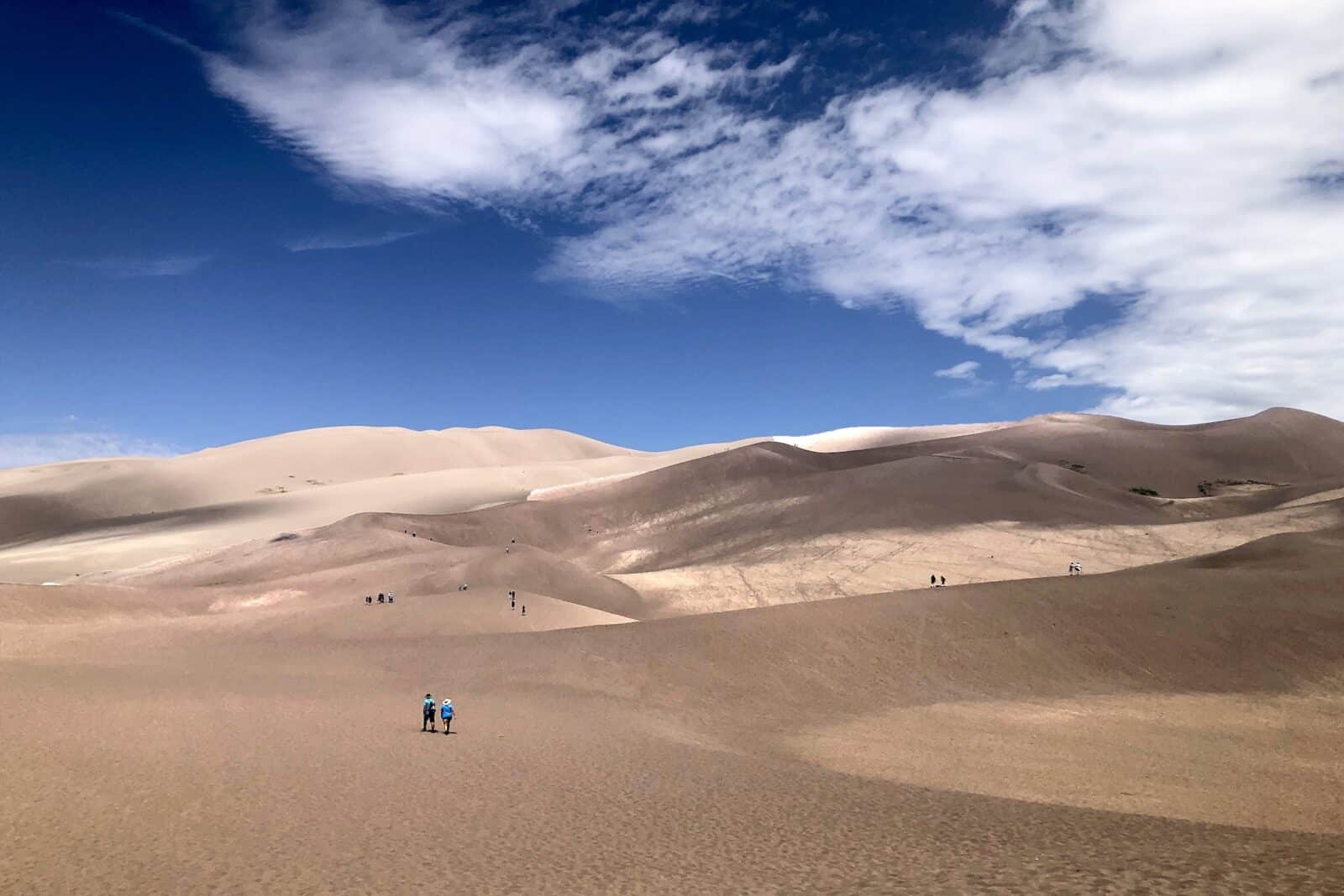 Hikers walking on the dunes at The Great Sand Dunes National Park in Colorado